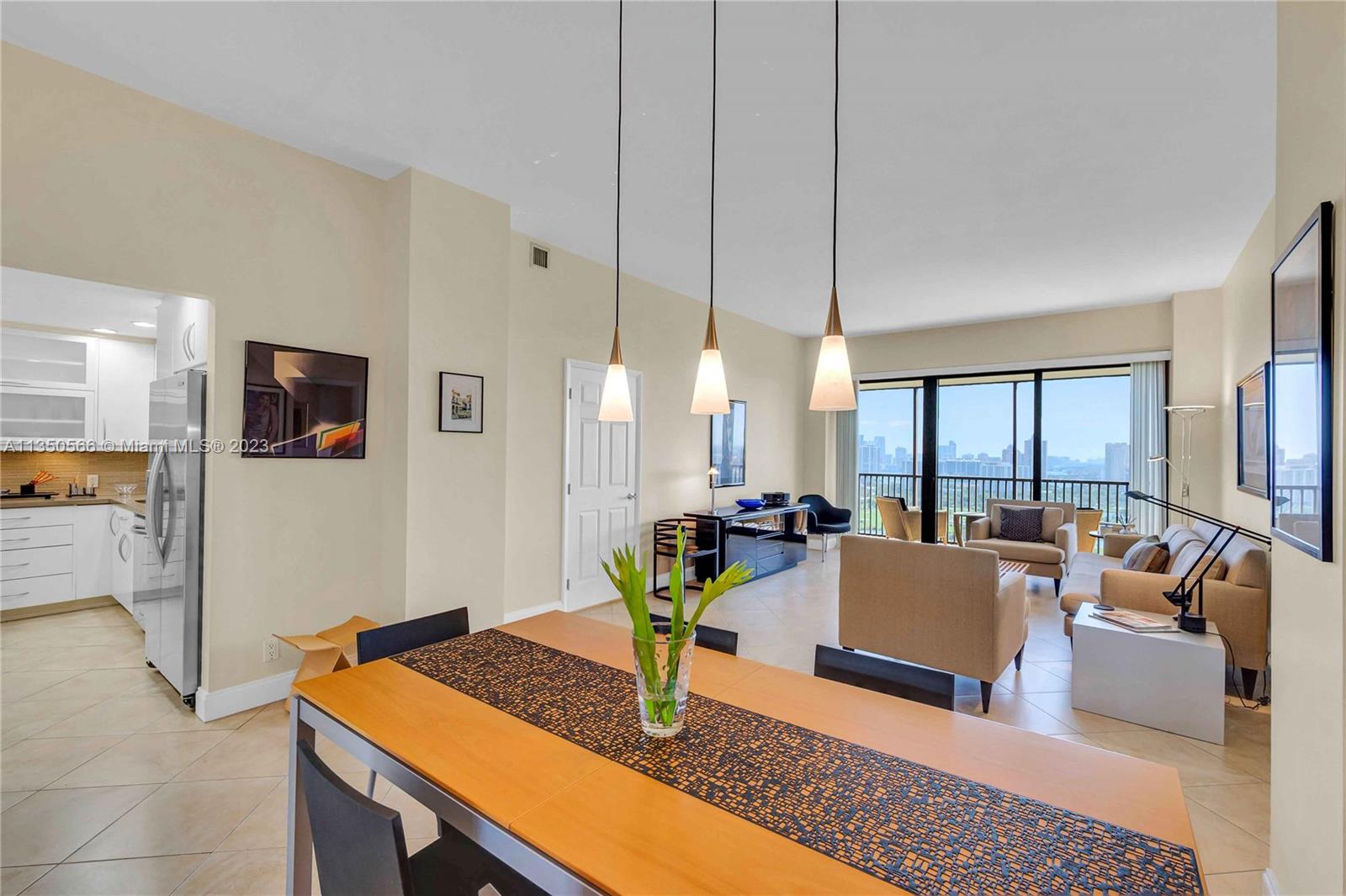 Large dining area looking into kitchen and living room