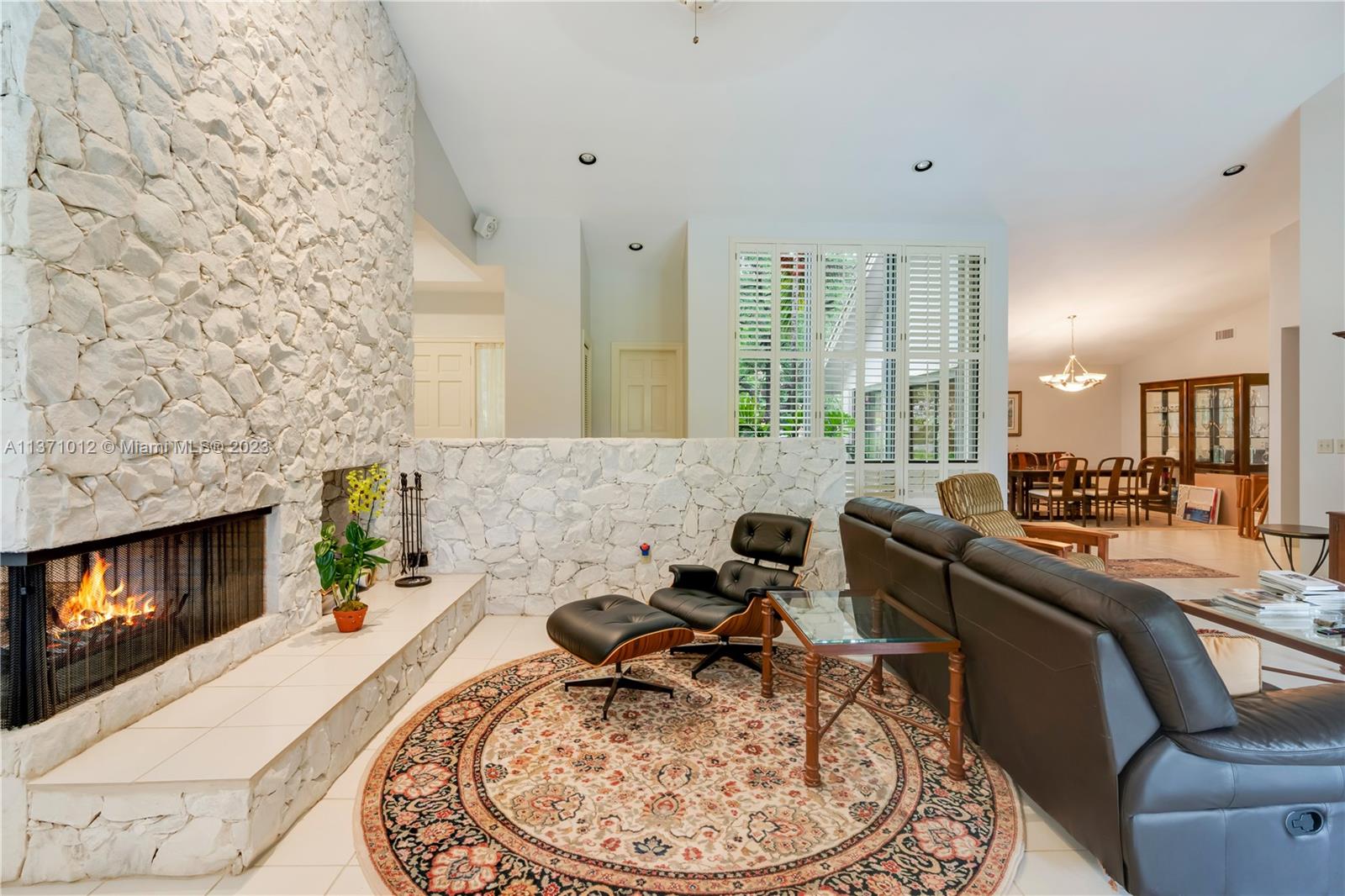 Comfortable Living room with volume ceilings and a large fireplace feature