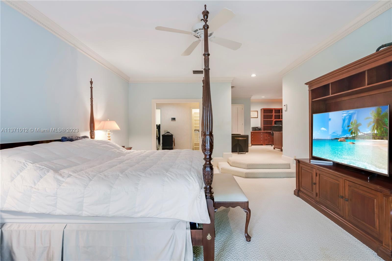 spacious master bedroom with a view of the pool