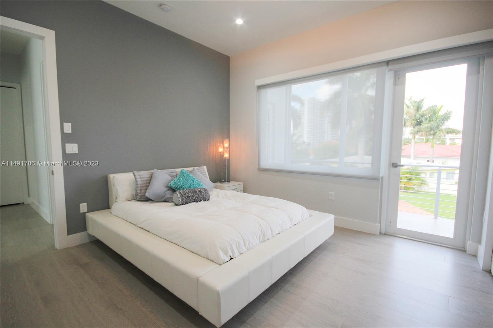 Upstairs first bedroom with balcony.