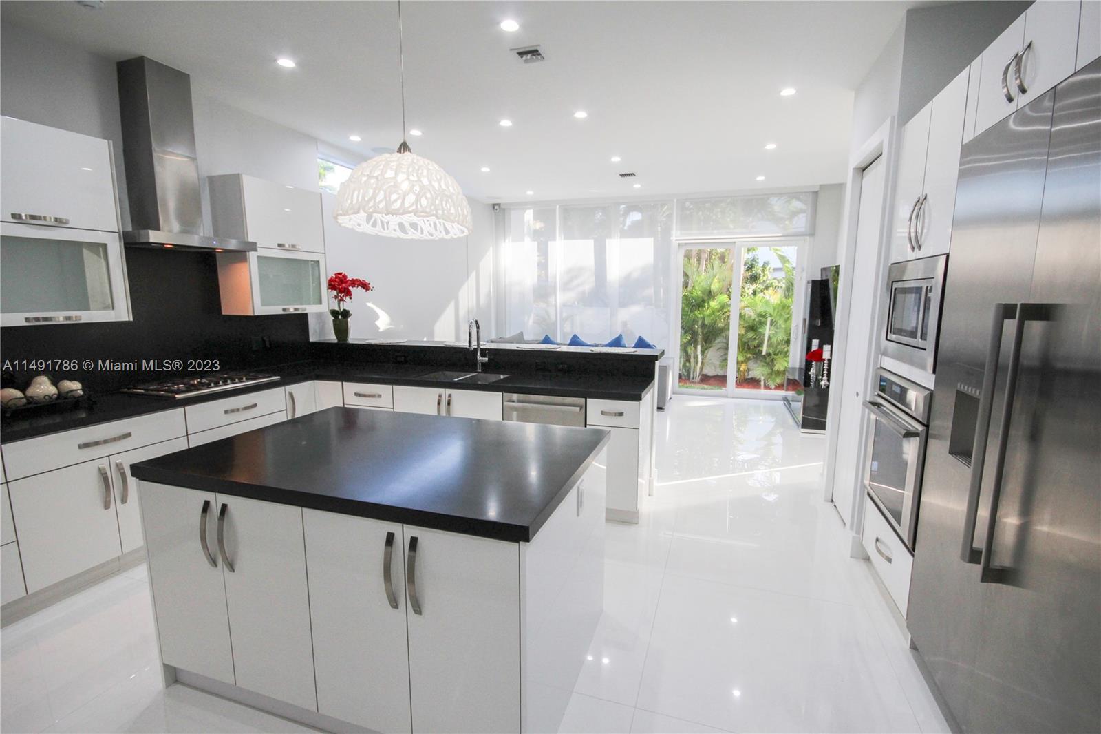 Cooking island and Thermador fridge.