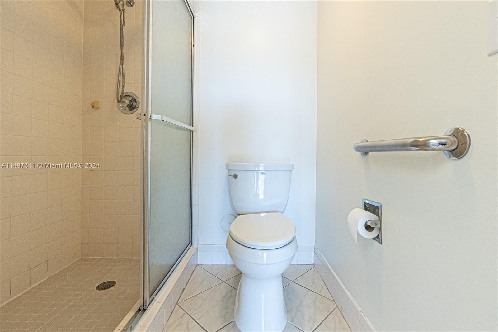 Ensuite Bathroom Shower & Toilet w/ Privacy Pocket Door in Master Bedroom