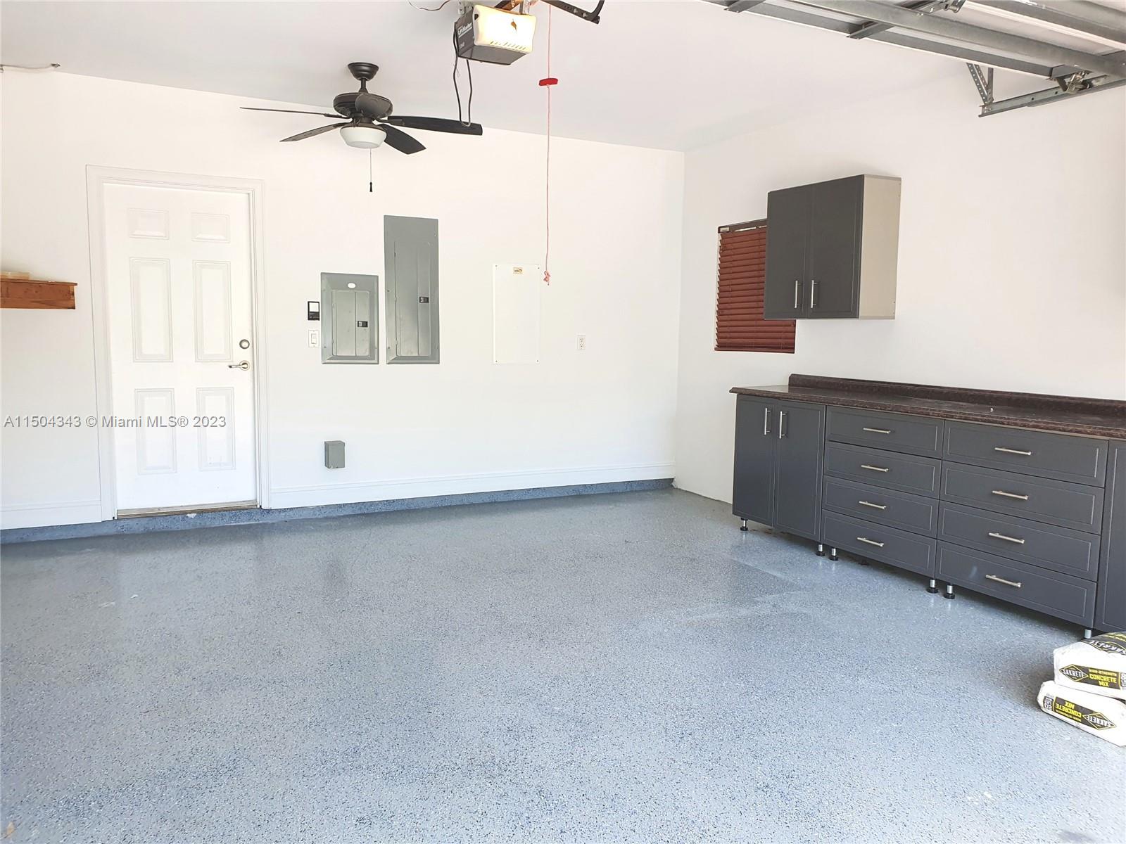 The garage features extra storage space in the cabinets.