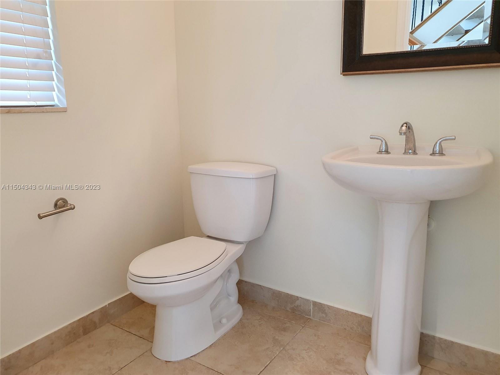 This powder room is located near the front door.
