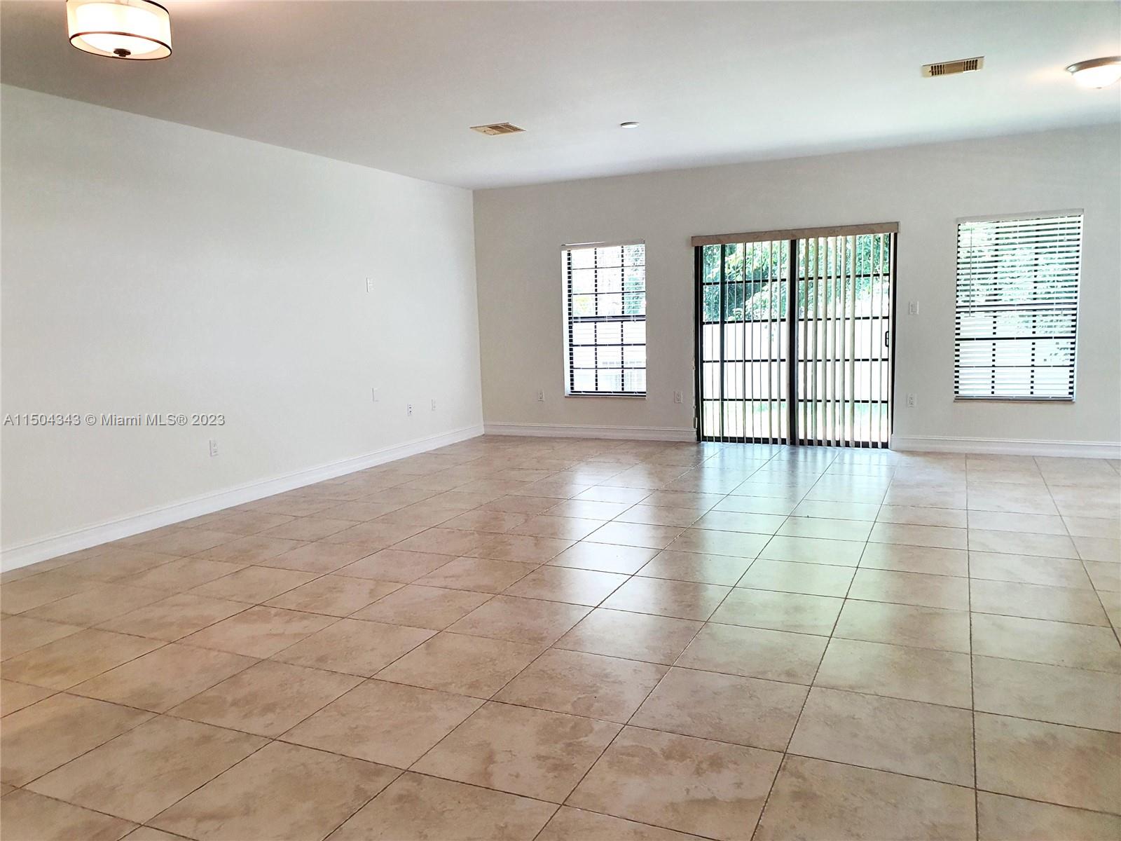 Expansive view of the living/dining room area as seen from the entrance.