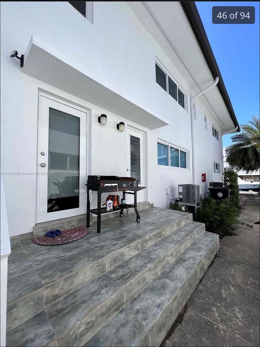 unit 1 side patio and second door entrance facing dock