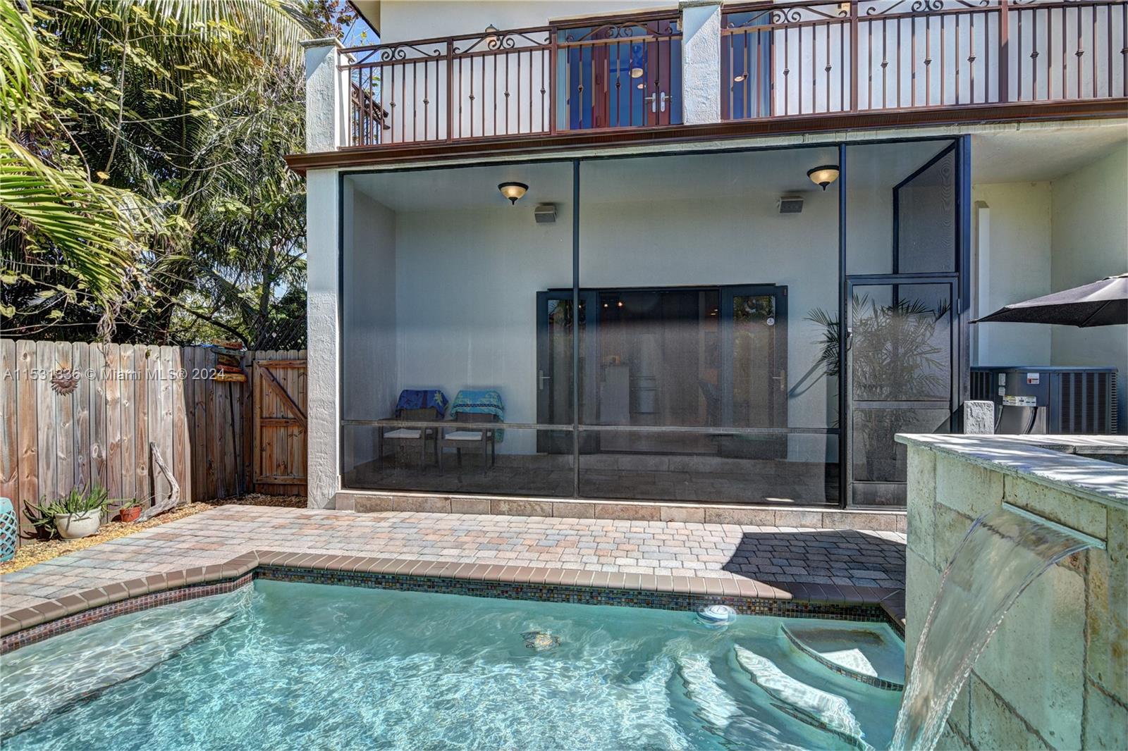 Large balcony from Master bedroom overlooks the patio and pool.  You can use the side door on the left to walk towards the front of the house.