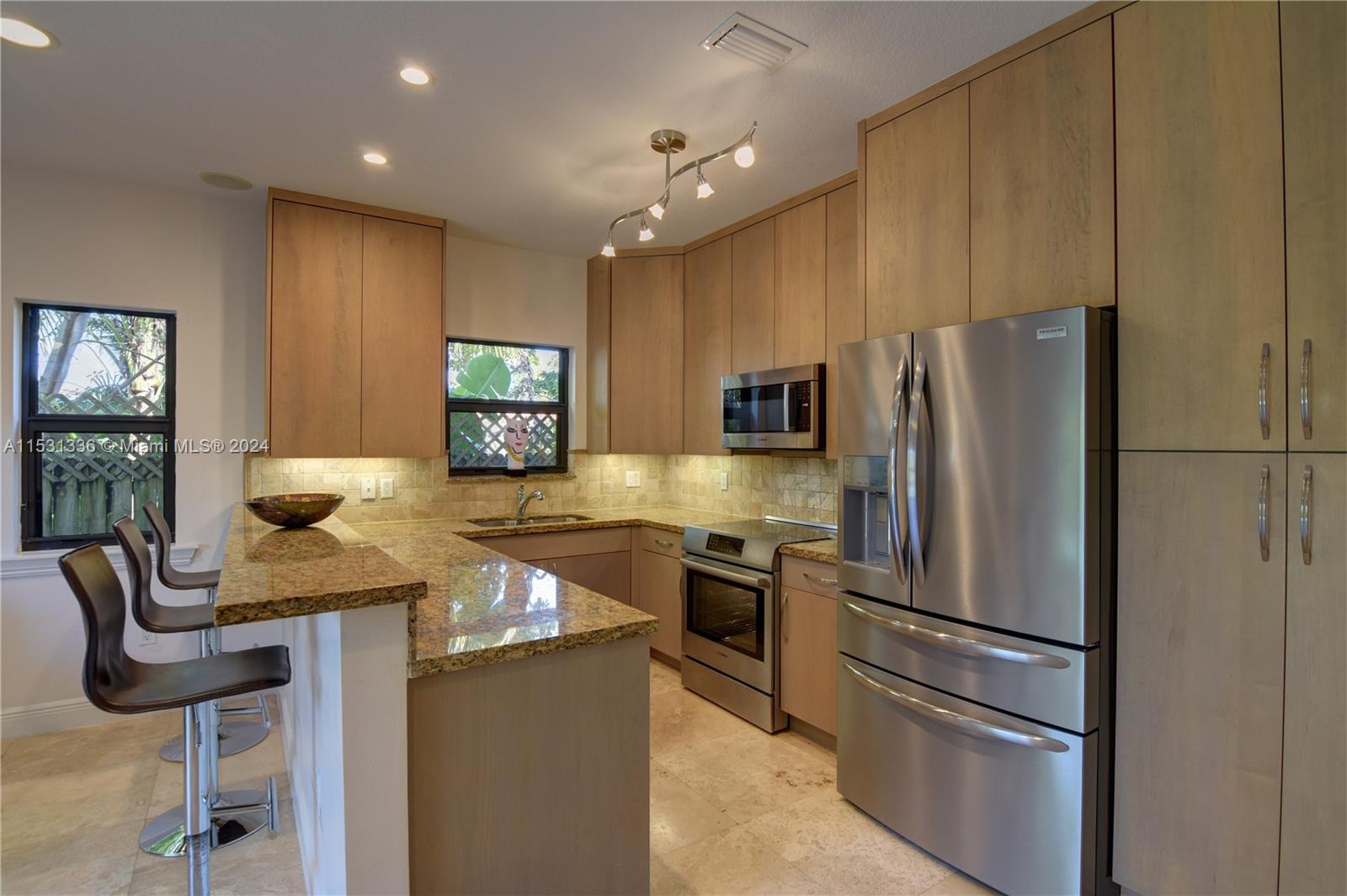 The kitchen overlooks the beautiful pool area