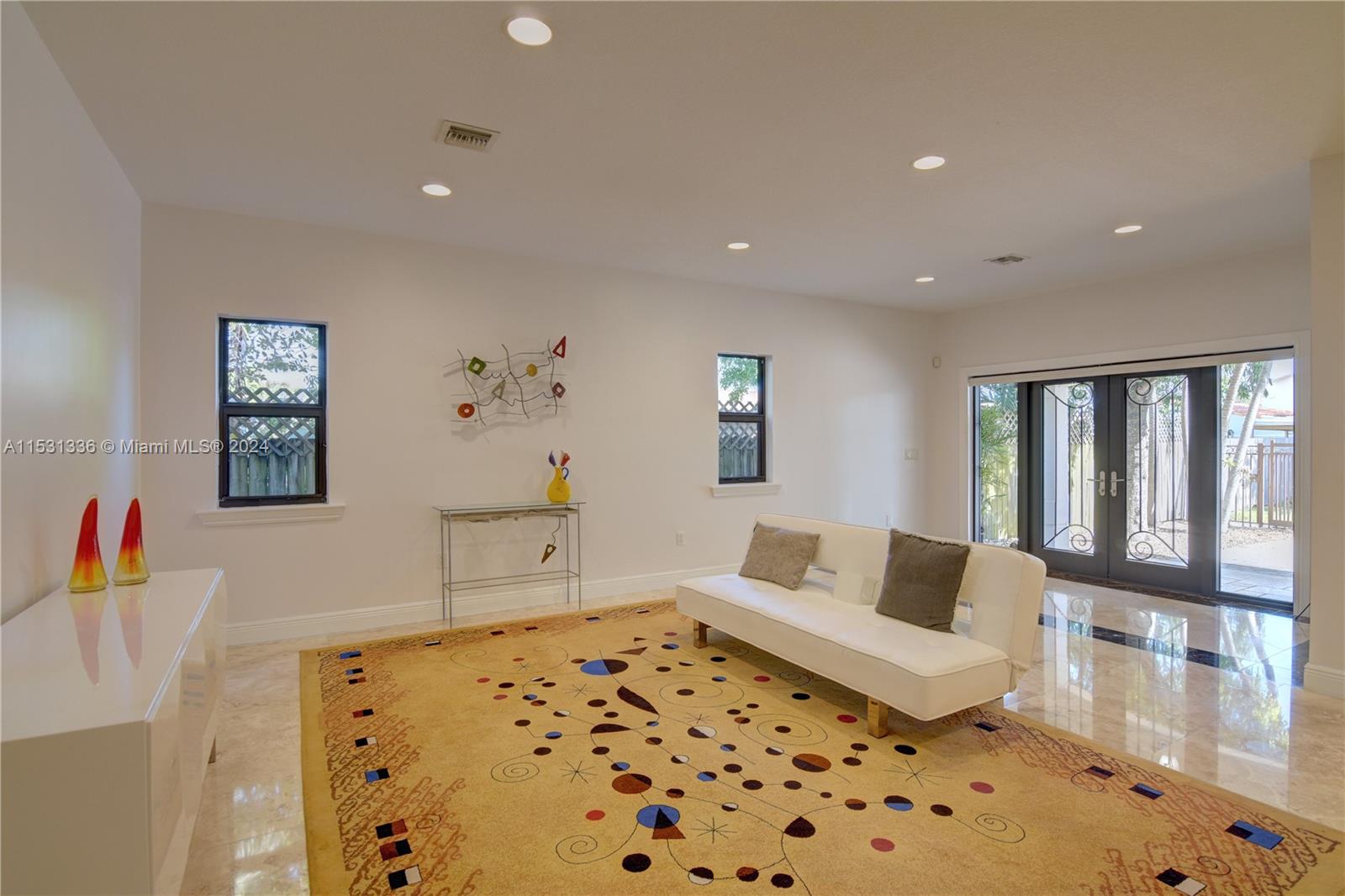 Very spacious living room with lots of natural light coming in.