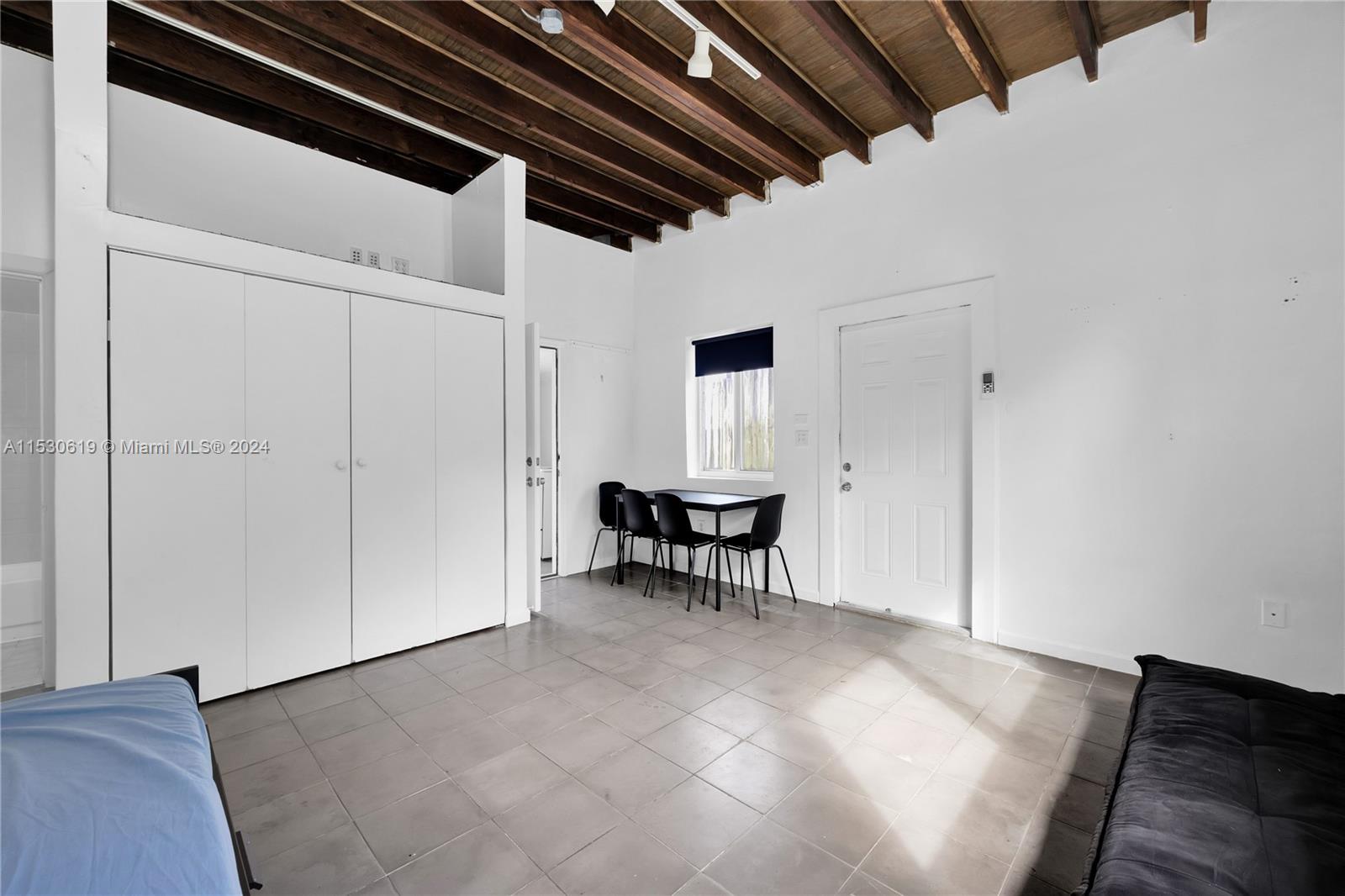 Studio Guest Cottage with dining area, kitchen, full bath and open-beam ceiling.