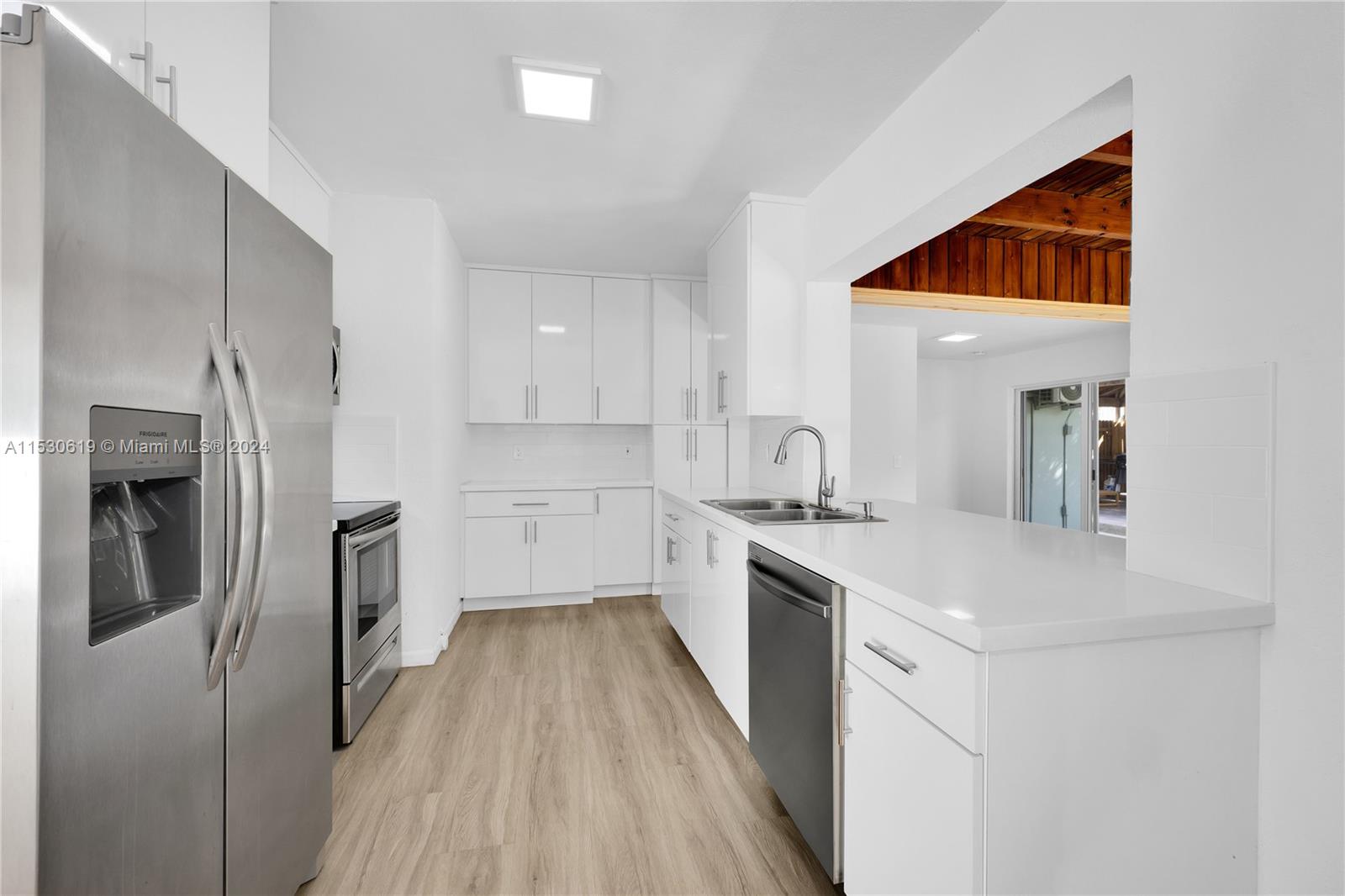 New Kitchen with S/S appliances, pass thru to family room breakfast counter.