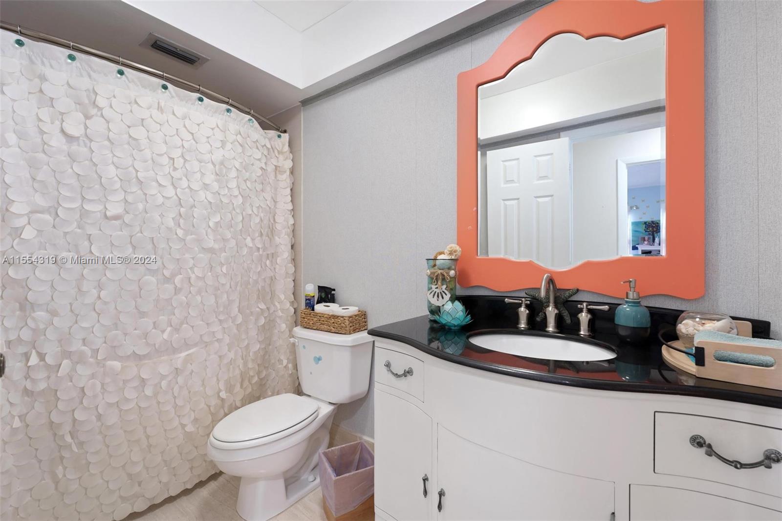 Guest bathroom is also a cabana bathroom with access to the pool area. Perfect for entertaining!