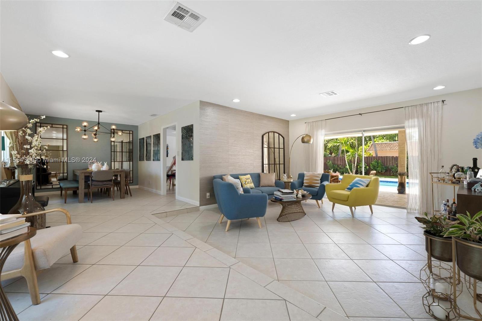 Spacious, open living and dining room areas feature custom accent walls and TONS of natural light with beautiful views of lush landscaping in the front or your backyard paradise. Sliding door in living room opens completely to the backyard.