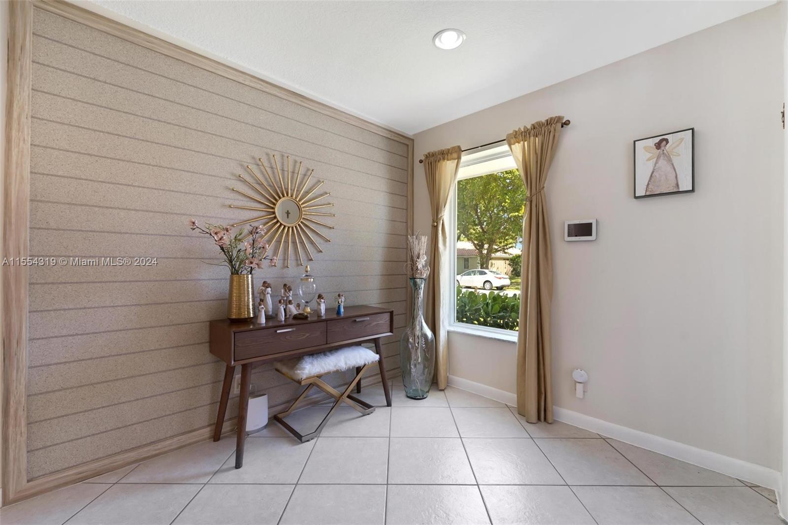 Welcome home! As you walk in you are greeted by a nice sized foyer area with a custom shiny cork wall paper which adds that designer touch.
