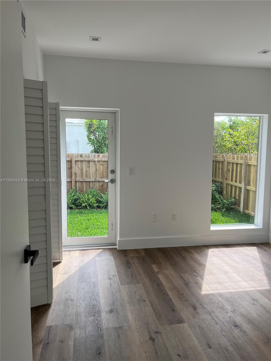 First floor bedroom with backyard/patio access and lots of natural light
