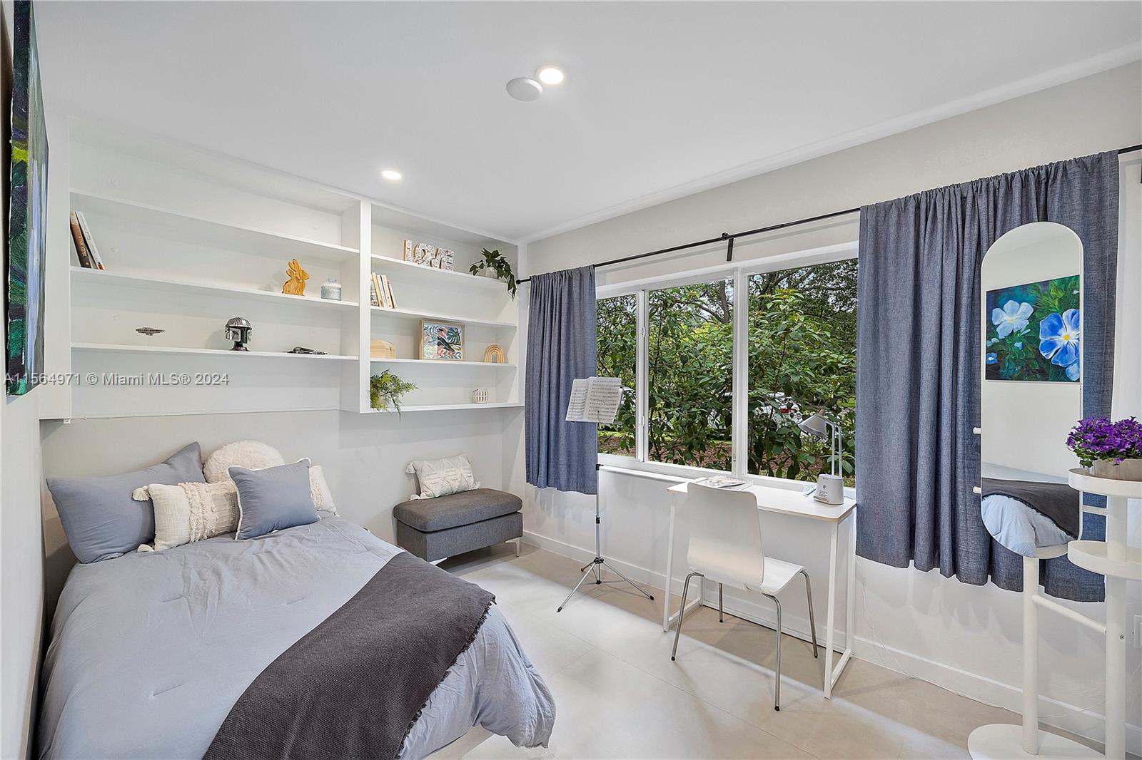 This beautiful room features built-in shelves and walk-in closet. Large windows flood the space with natural light.