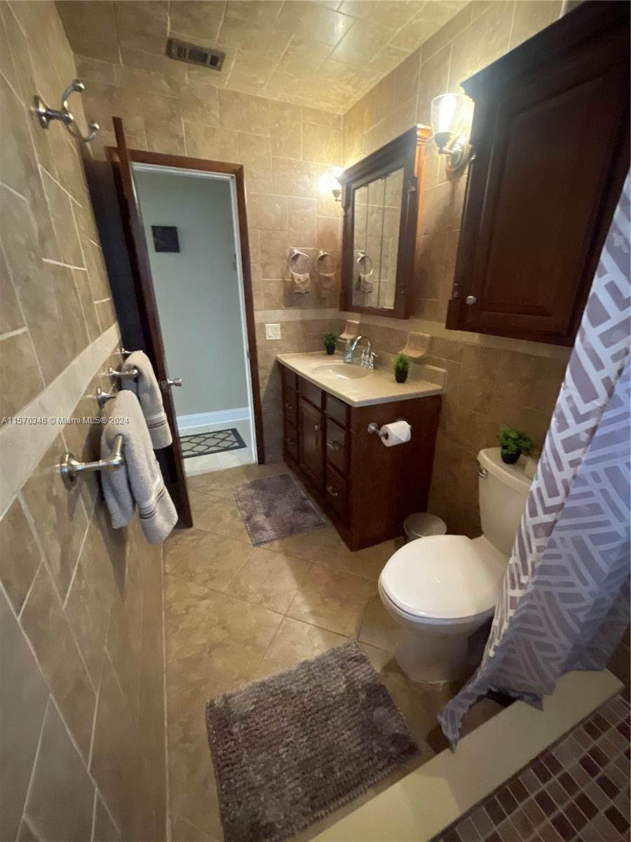 Step into sophistication in our second bathroom—a haven reminiscent of a high-end spa. A custom vanity seamlessly combines functionality with elegance, boasting ample storage. Enhanced by polished wood cabinets and exquisite mirrors, this space exudes timeless charm and invites you to unwind in luxury.