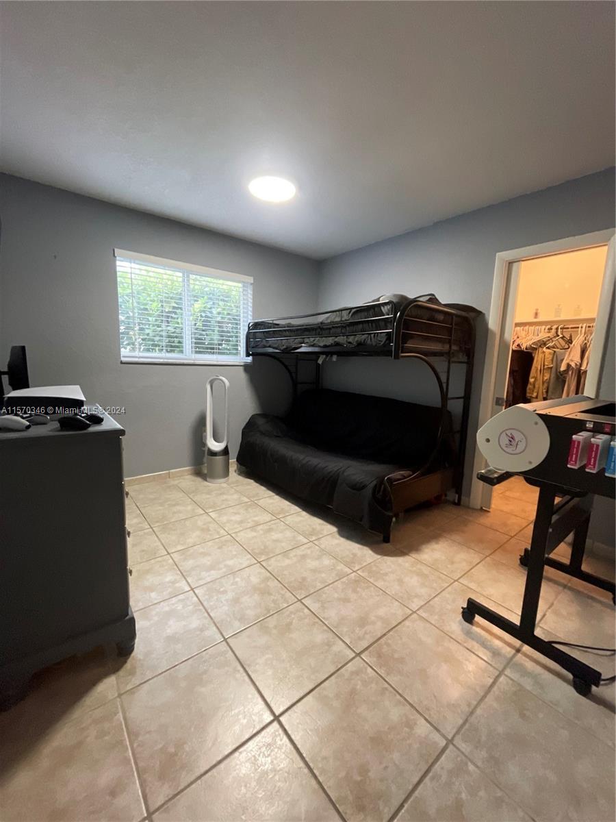 Bedroom number three with gorgeous tile floors, including a walking closet that features a pocket door for conserving on space.