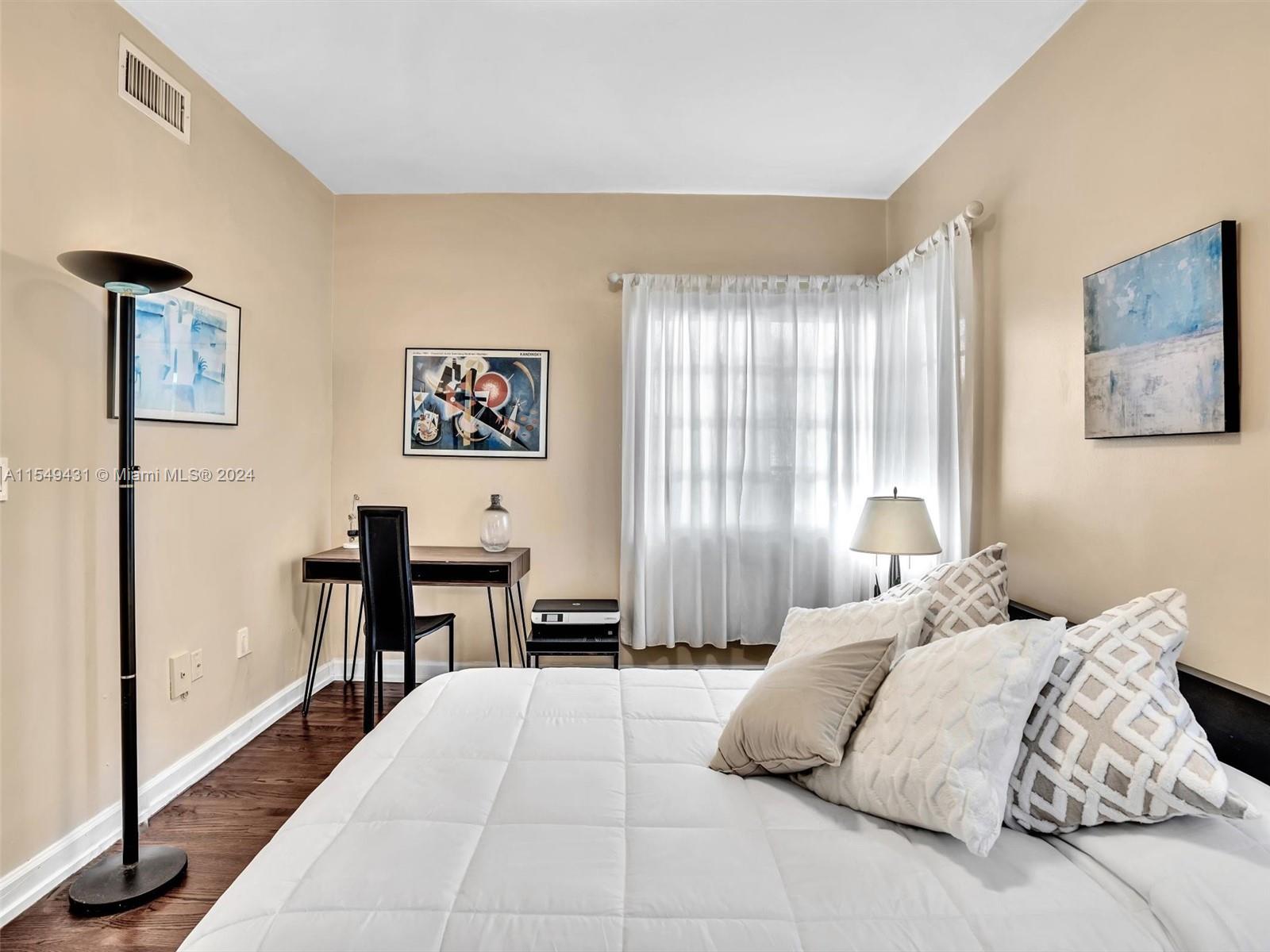 Bedroom large enough for work space desk.