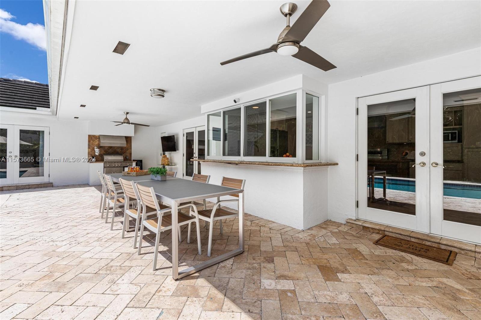 Nice pass-through window from kitchen and bar area for entertaining under the covered patio