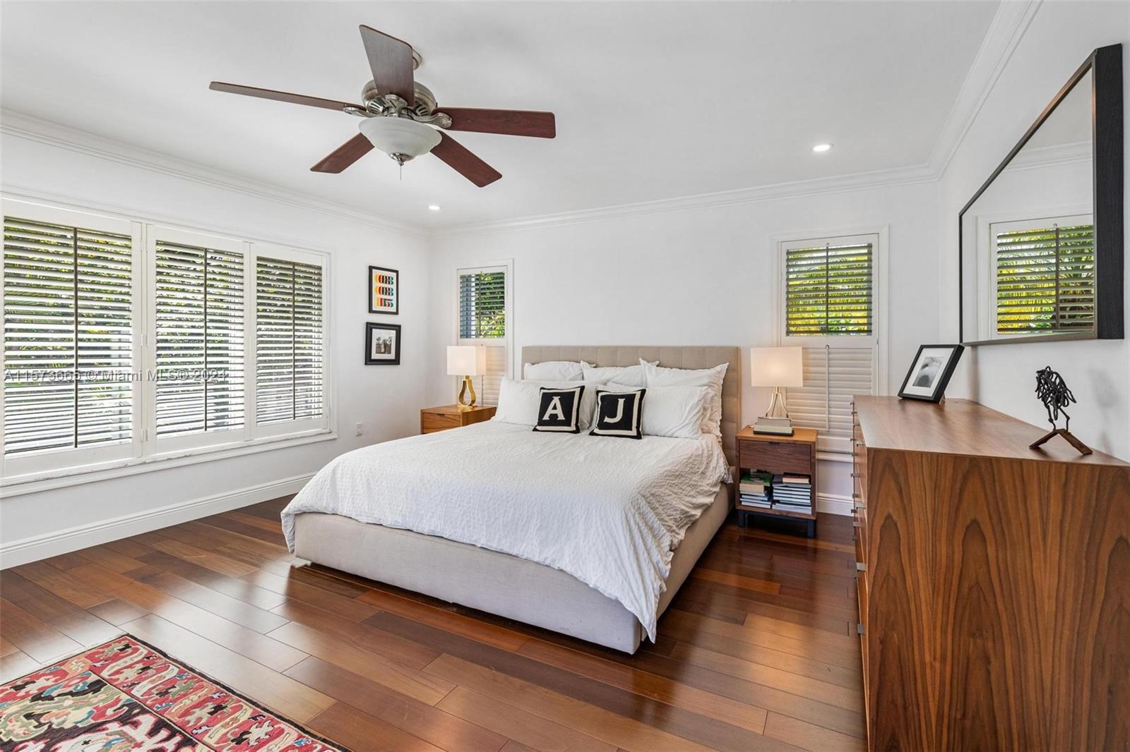 Primary bedroom light and bright, french doors to pool area